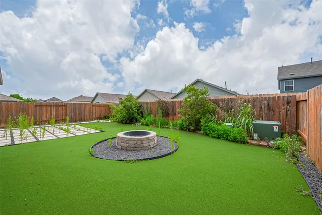 a view of a table and chairs in backyard