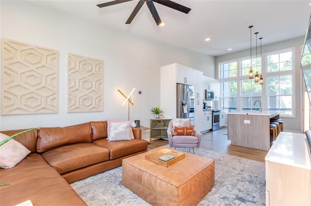 912 Brees Court Atlanta, GA 30318 - Photo 16 of 33 a living room with furniture kitchen view and a large window