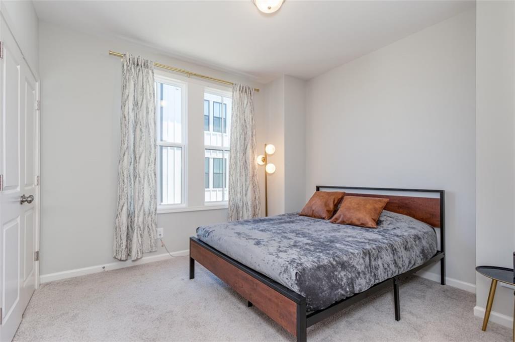 912 Brees Court Atlanta, GA 30318 - Photo 18 of 33 a bedroom with a bed and window