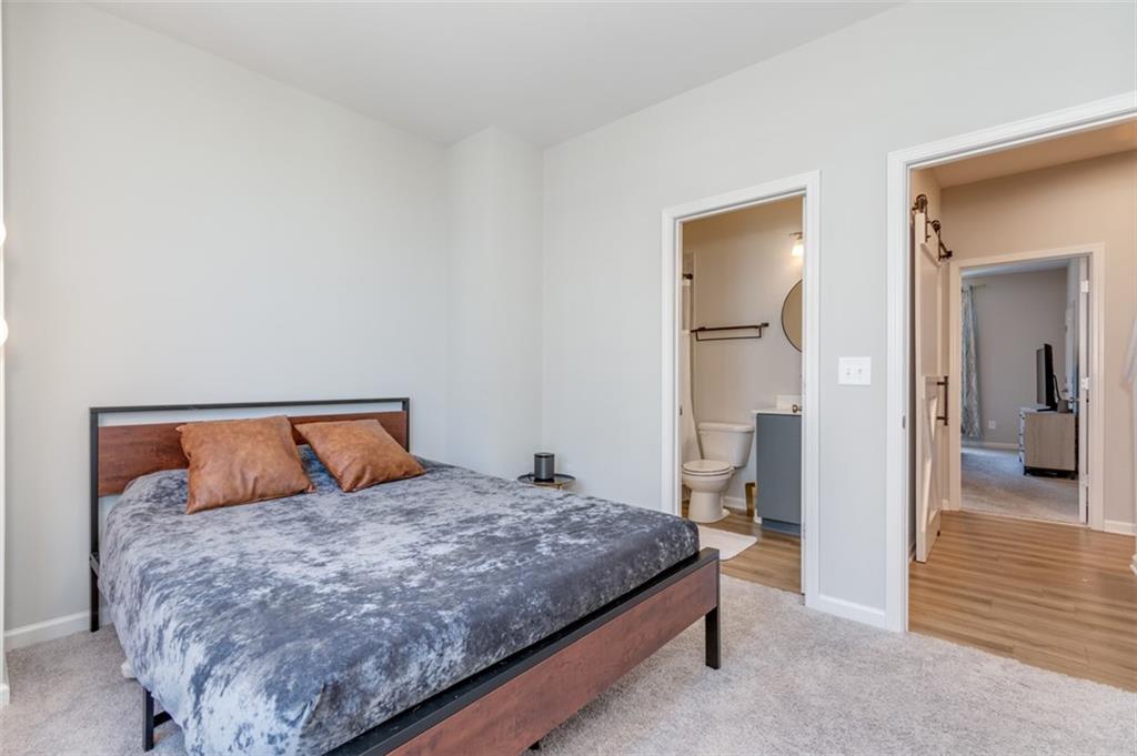 912 Brees Court Atlanta, GA 30318 - Photo 19 of 33 a bedroom with a bed and wooden floor