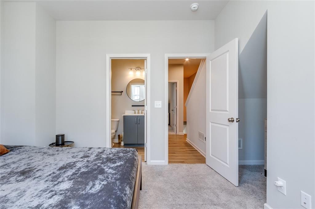 912 Brees Court Atlanta, GA 30318 - Photo 20 of 33 a bedroom with a bed and a mirror