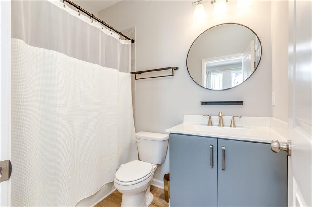 912 Brees Court Atlanta, GA 30318 - Photo 21 of 33 a bathroom with a toilet a sink and a mirror