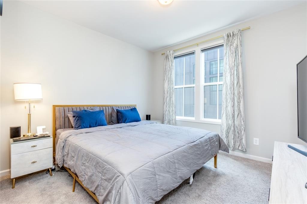 912 Brees Court Atlanta, GA 30318 - Photo 28 of 33 a bedroom with a large bed and a window