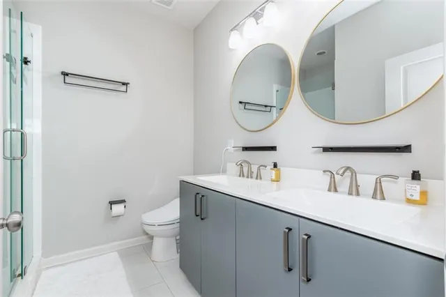 a bathroom with a toilet a sink and a mirror