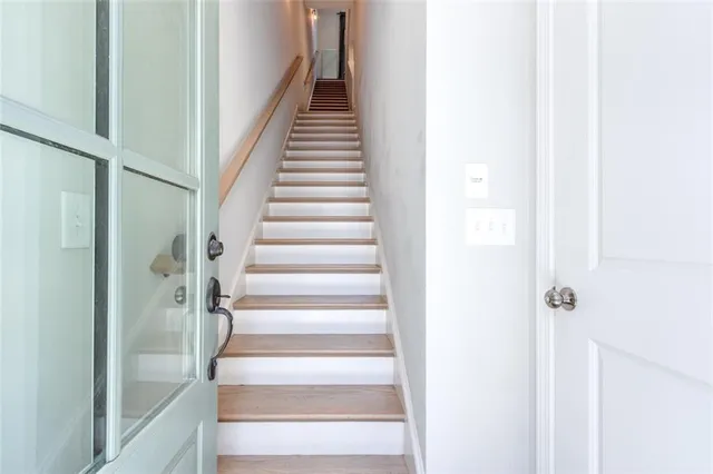 a large kitchen with stainless steel appliances a large counter top a stove a refrigerator and a view of living room