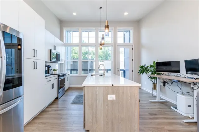 a kitchen with counter space appliances and wooden floor