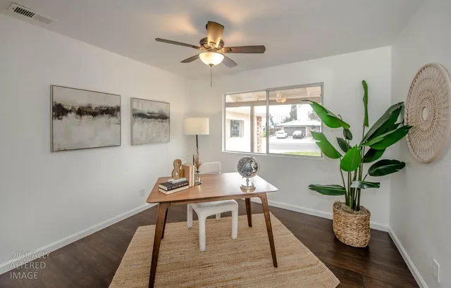 a workspace with furniture and a potted plant