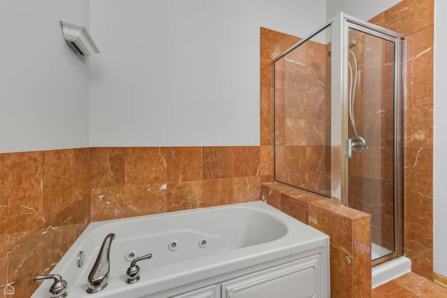 a bathroom with a tub and shower