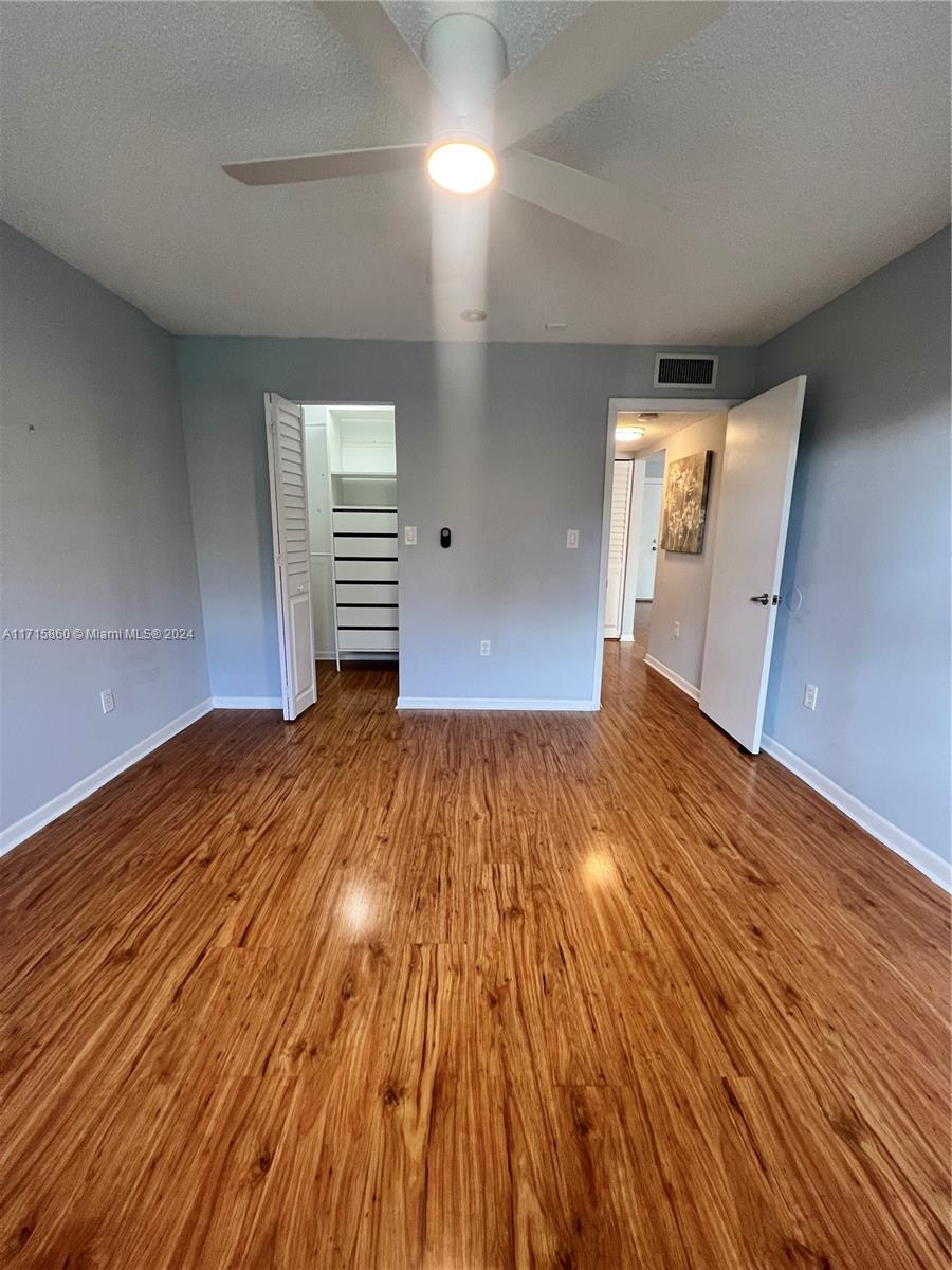 8281 Southwest 128th Street, Unit 213 Pinecrest, FL 33156 - Photo 6 of 8 a view of empty room with wooden floor