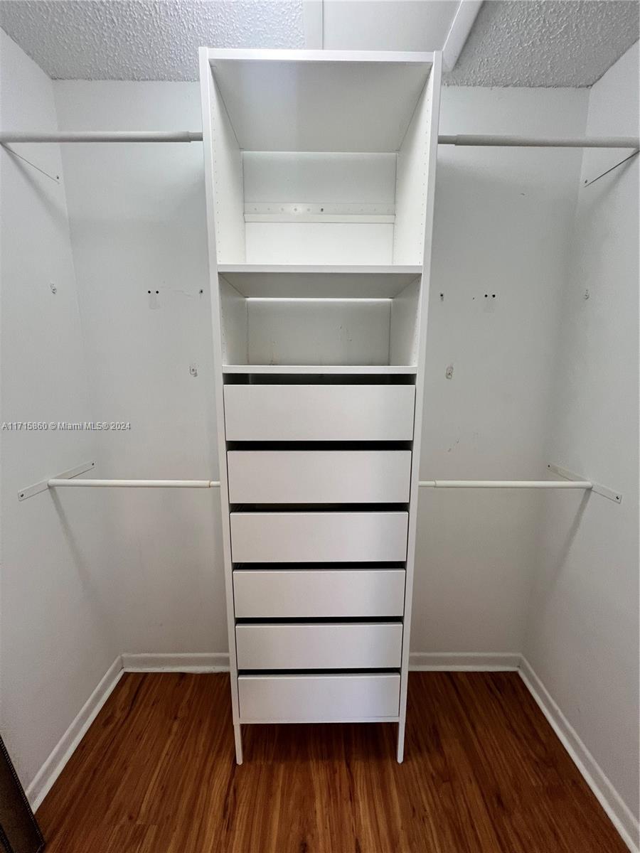 8281 Southwest 128th Street, Unit 213 Pinecrest, FL 33156 - Photo 7 of 8 a view of walk in closet with empty racks