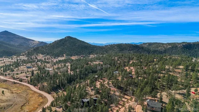 a view of a mountain range in a cloudy sky