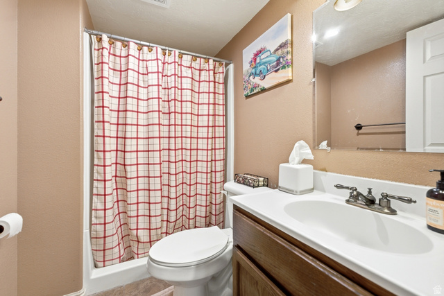 5196 Rodeo Circle Oakley, UT 84055 - Photo 37 of 57 Full bathroom featuring a shower/tub combination with a white surround, a toilet, and a vanity with a white countertop and integrated sink