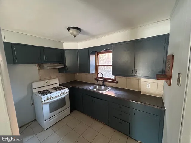 a kitchen with a sink stove and microwave