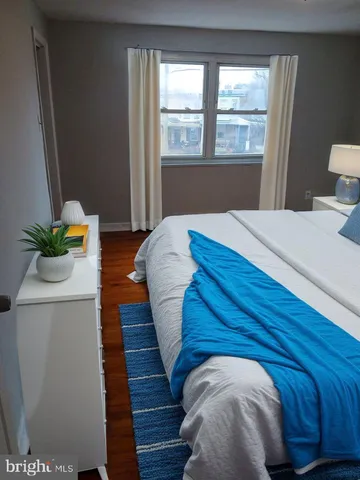 a bed sitting in a bedroom next to a window