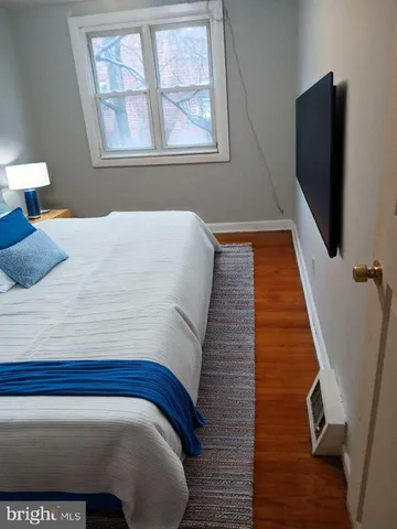 a bedroom with a bed and flat screen tv