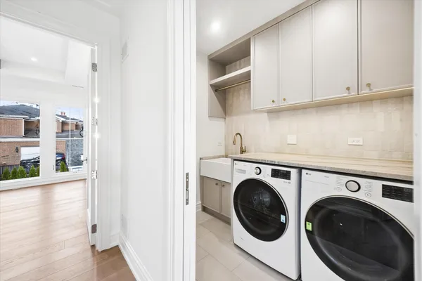 a utility room with sink dryer and washer