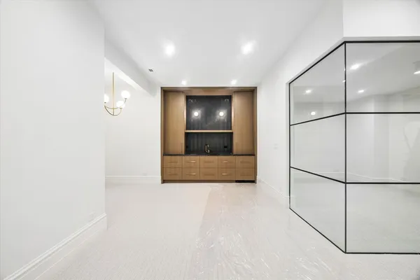 a view of an empty room with a kitchen