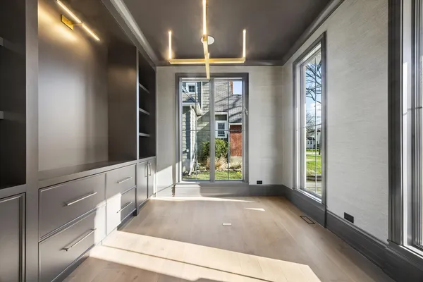 a view of entryway with a floor to ceiling window and wooden floor