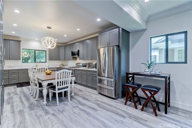 a kitchen with stainless steel appliances a sink stove and cabinets