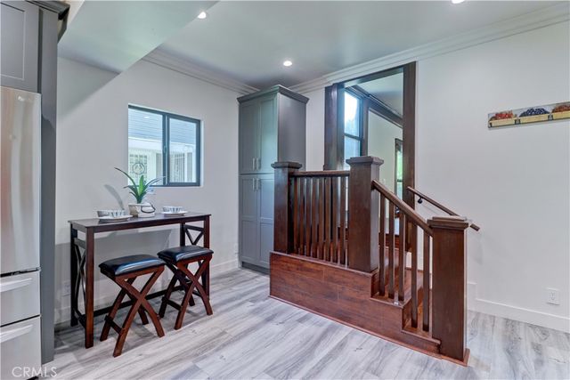 a dining room with furniture and a floor to ceiling window