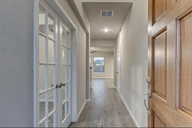 a view of a hallway with a wooden floors