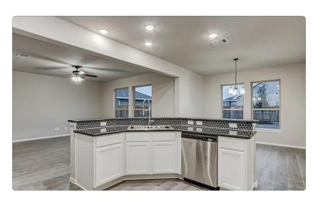 a kitchen with a sink and cabinets