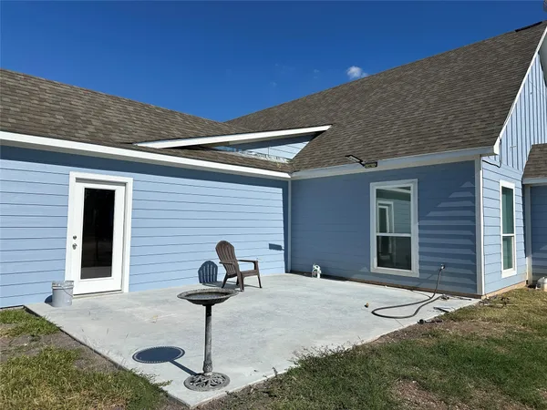 a view of an empty room and kitchen view