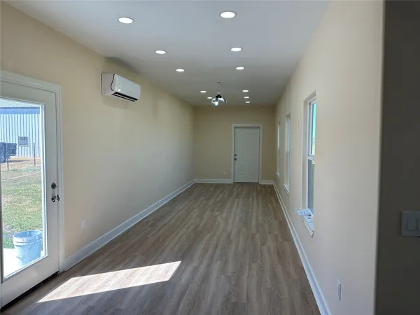 a kitchen with white cabinets and sink