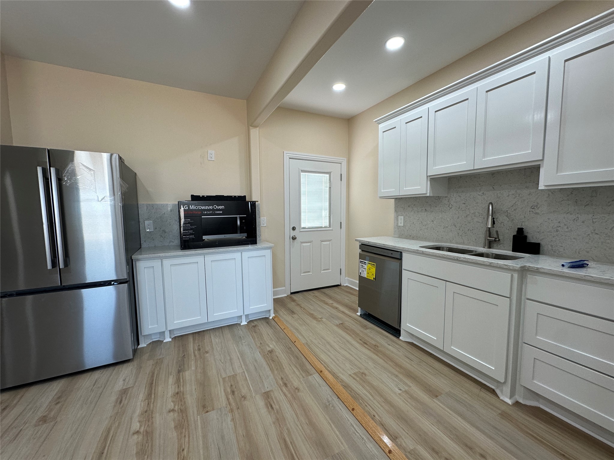 4334 Maass Road Burton, TX 77835 - Photo 22 of 44 a kitchen with white cabinets and stainless steel appliances