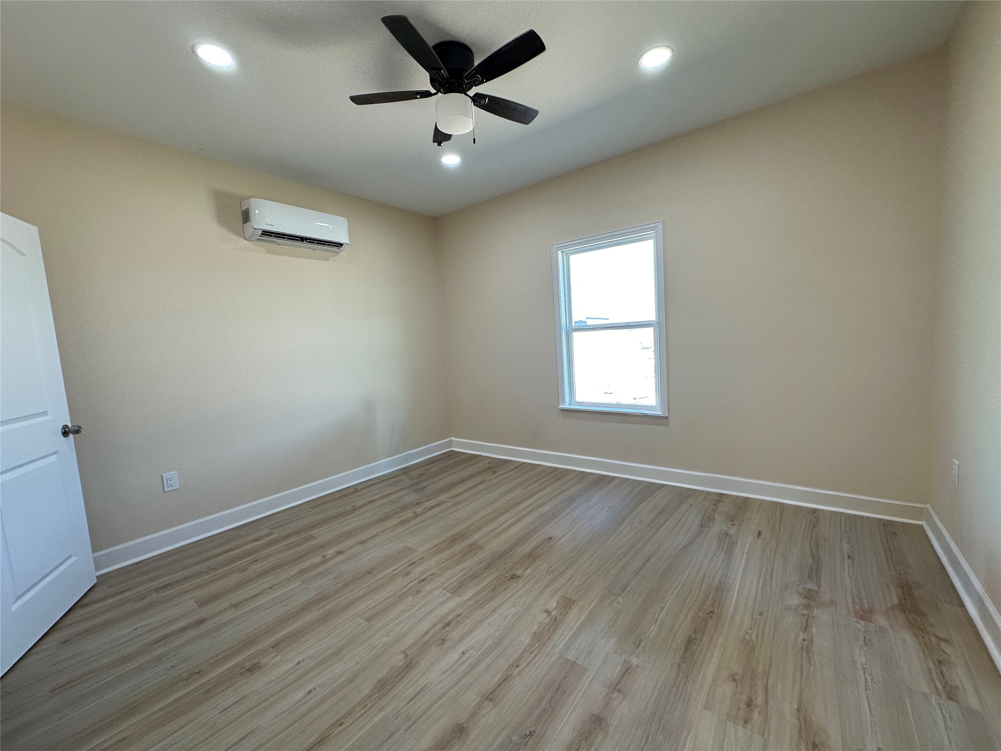 4334 Maass Road Burton, TX 77835 - Photo 24 of 44 an empty room with wooden floor and windows