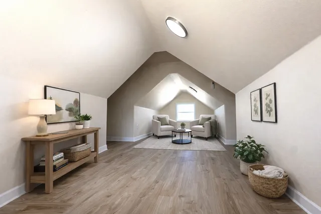 a bedroom with a bed and a lamp with wooden floor
