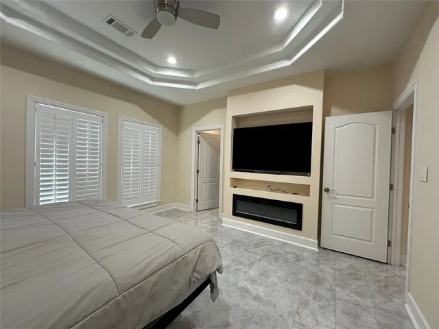 a bedroom with bed and flat screen tv
