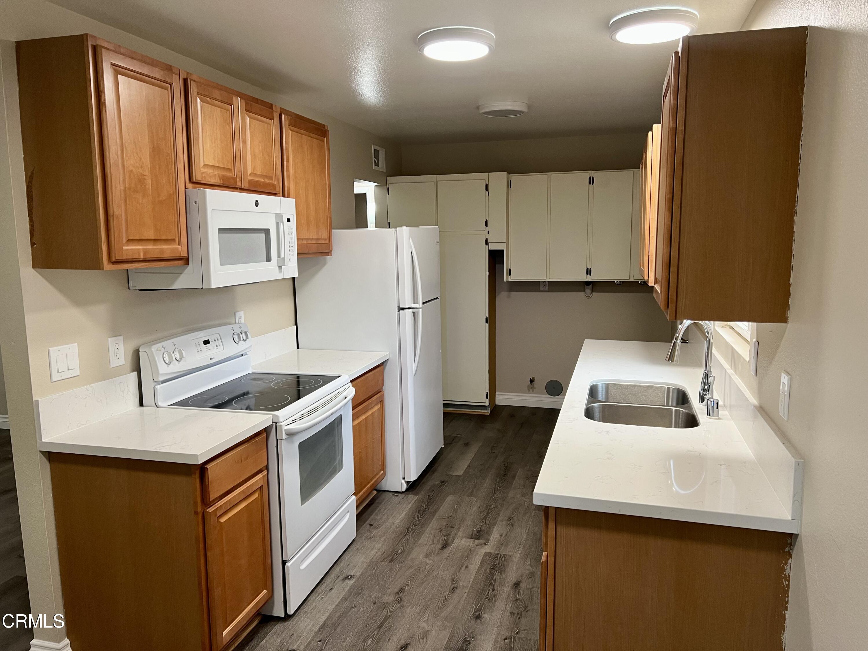 1693 Sequoia Avenue Simi Valley, CA 93063 - Photo 2 of 18 a kitchen with stainless steel appliances a refrigerator a sink and wooden cabinets