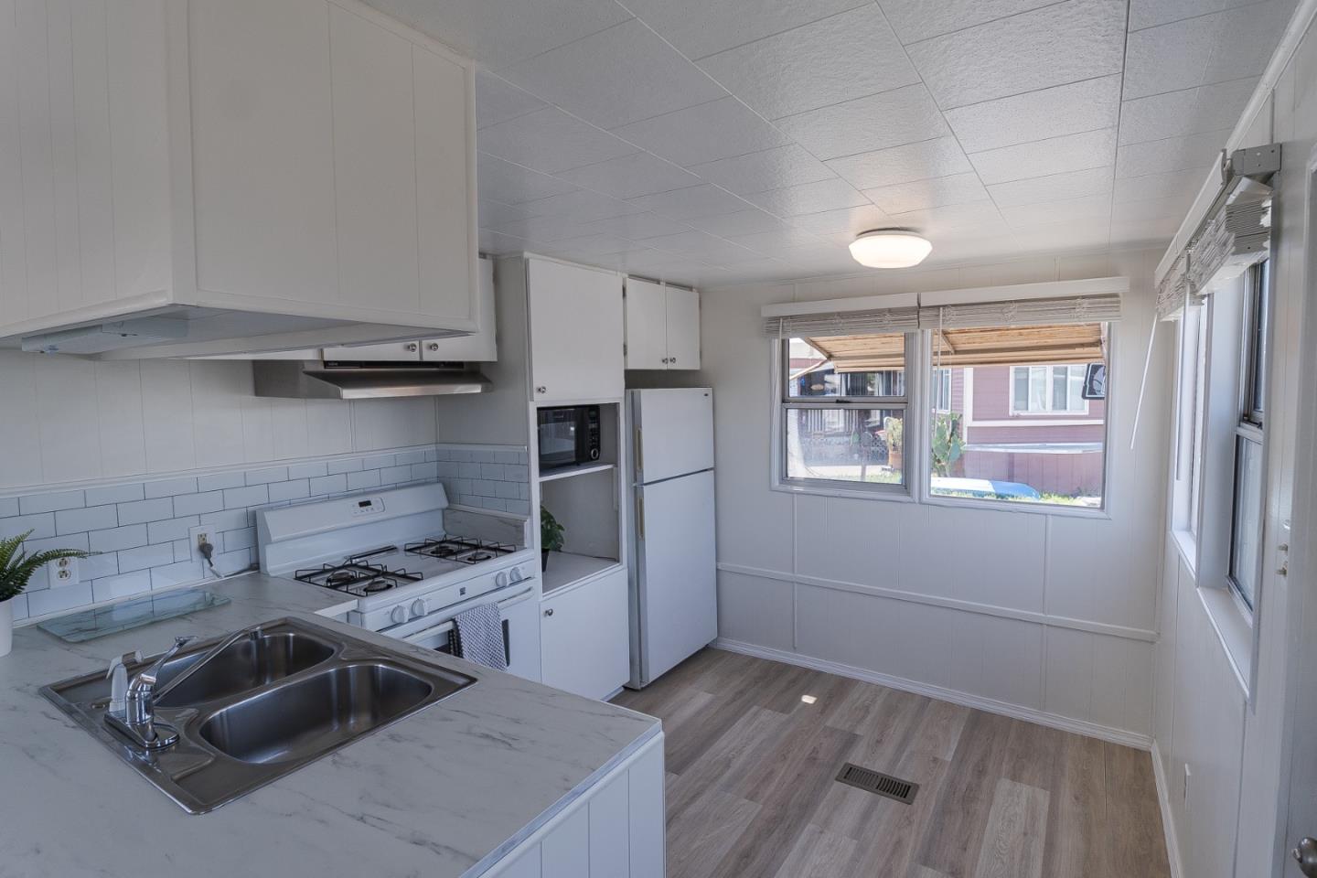 1740 Broadway, Unit 29 Vallejo, CA 94589 - Photo 4 of 12 a kitchen that has a sink cabinets counter space stainless steel appliances and a window