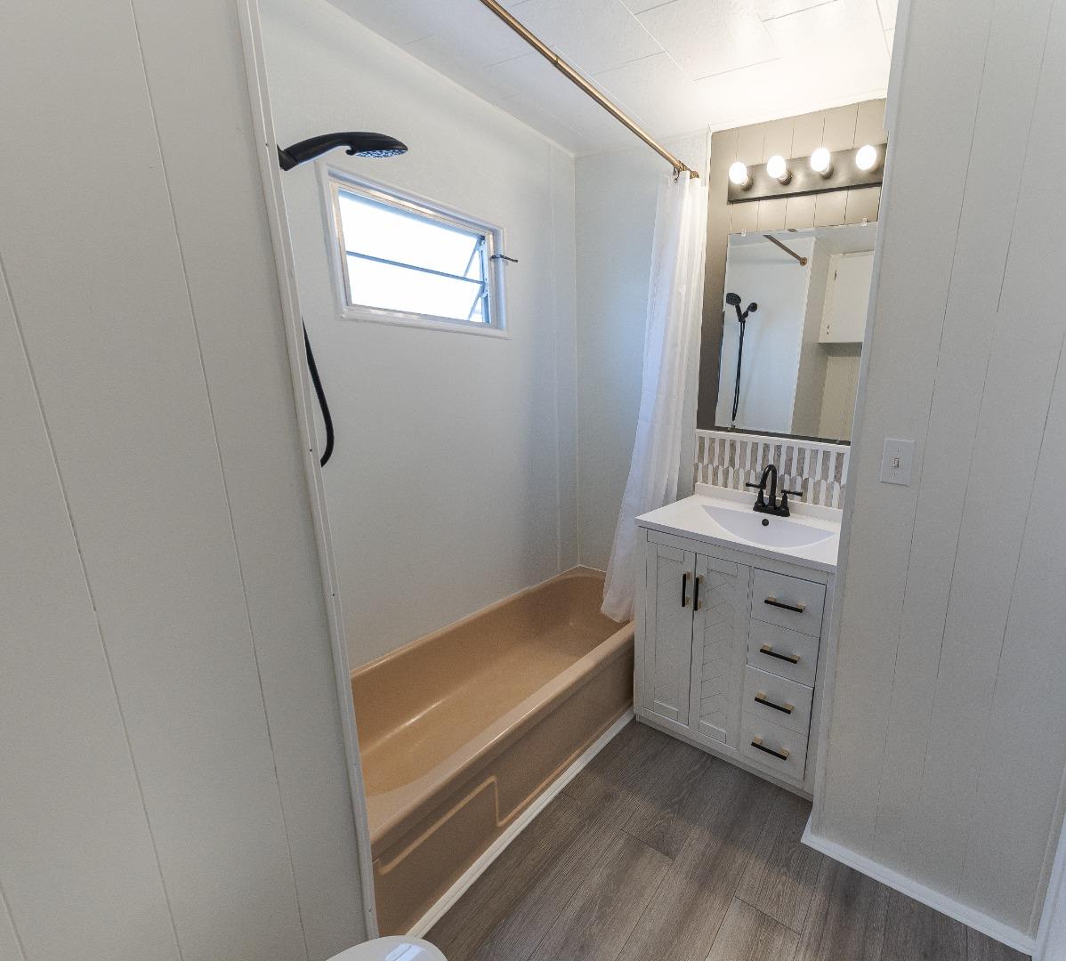 1740 Broadway, Unit 29 Vallejo, CA 94589 - Photo 6 of 12 a bathroom with a sink a mirror and a bathtub