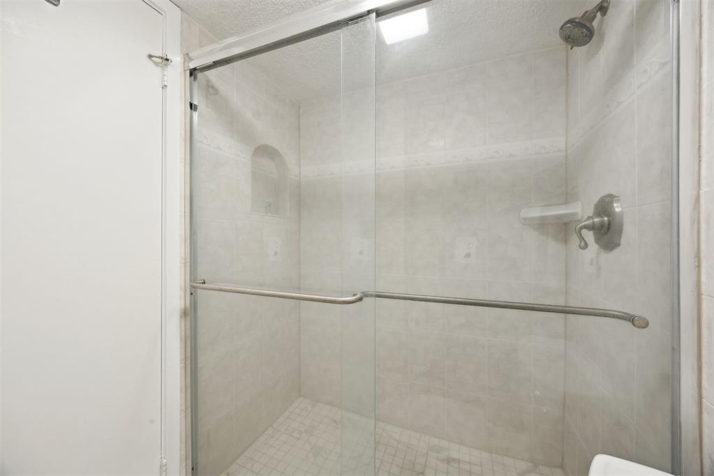 2021 Beachwood Road, Unit 2021 Fernandina Beach, FL 32034 - Photo 15 of 32 a bathroom with a glass shower door