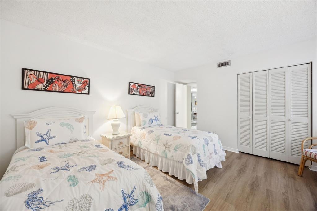 2021 Beachwood Road, Unit 2021 Fernandina Beach, FL 32034 - Photo 17 of 32 a bedroom with two beds and a walk in closet