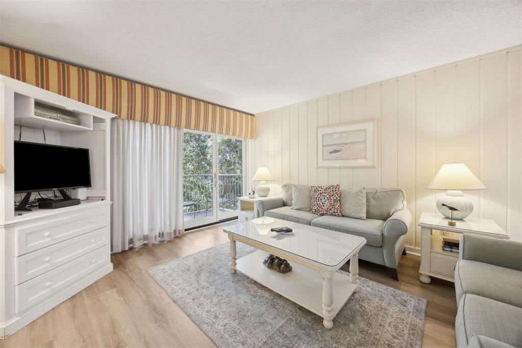 2021 Beachwood Road, Unit 2021 Fernandina Beach, FL 32034 - Photo 3 of 32 a living room with furniture a flat screen tv and a window