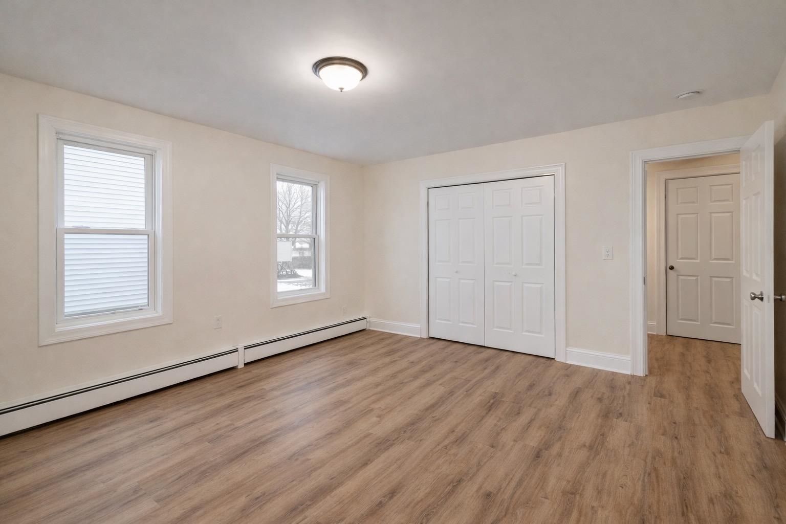 64 South 13th Street, Unit 2 Newark, NJ 07107 - Photo 5 of 11 an empty room with wooden floor and windows