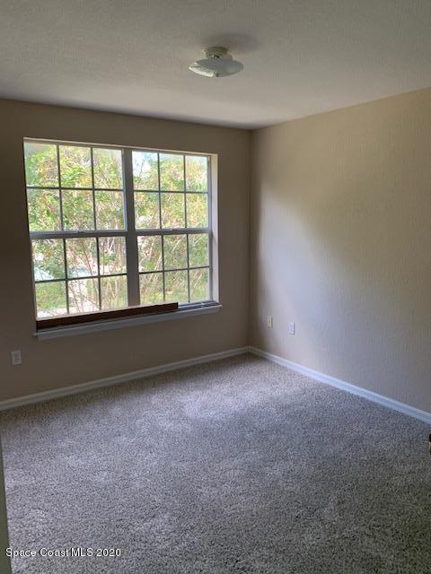 110 Colibri Way, Unit 105 Melbourne, FL 32901 - Photo 14 of 16 an empty room with a window