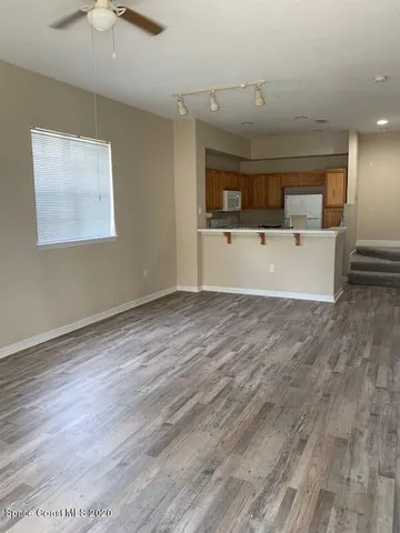 a view of room with window and a ceiling fan