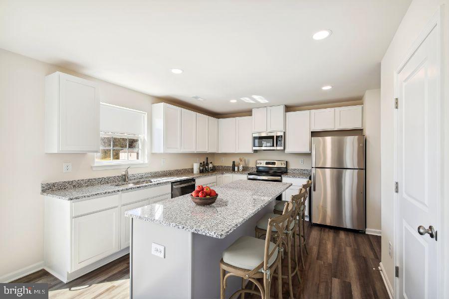 33 North Dupont Boulevard Georgetown, DE 19947 - Photo 6 of 12 a kitchen with stainless steel appliances granite countertop a refrigerator sink and cabinets