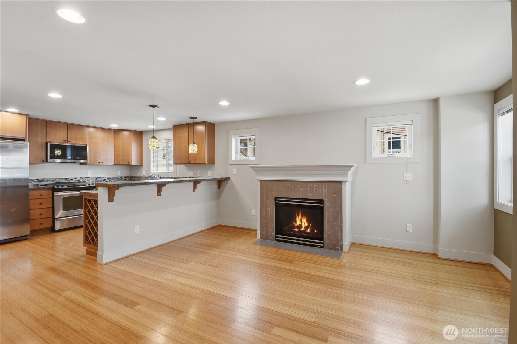 723 North 95th Street, Unit A Seattle, WA 98103 - Photo 6 of 20 a kitchen with stainless steel appliances granite countertop a stove top oven a sink and a refrigerator