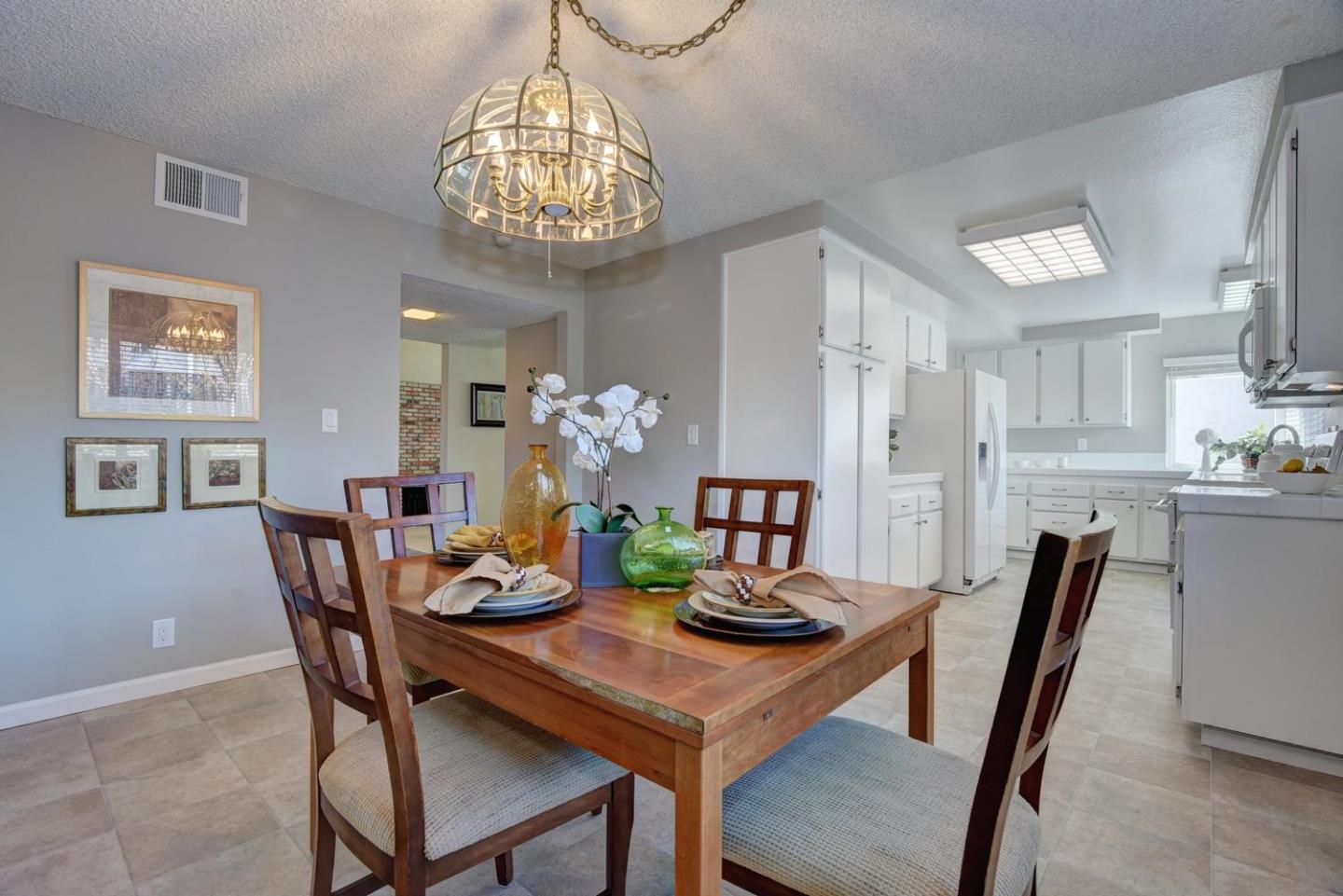 6429 McAbee Road San Jose, CA 95120 - Photo 12 of 28 a view of a dining room with furniture a chandelier and wooden floor