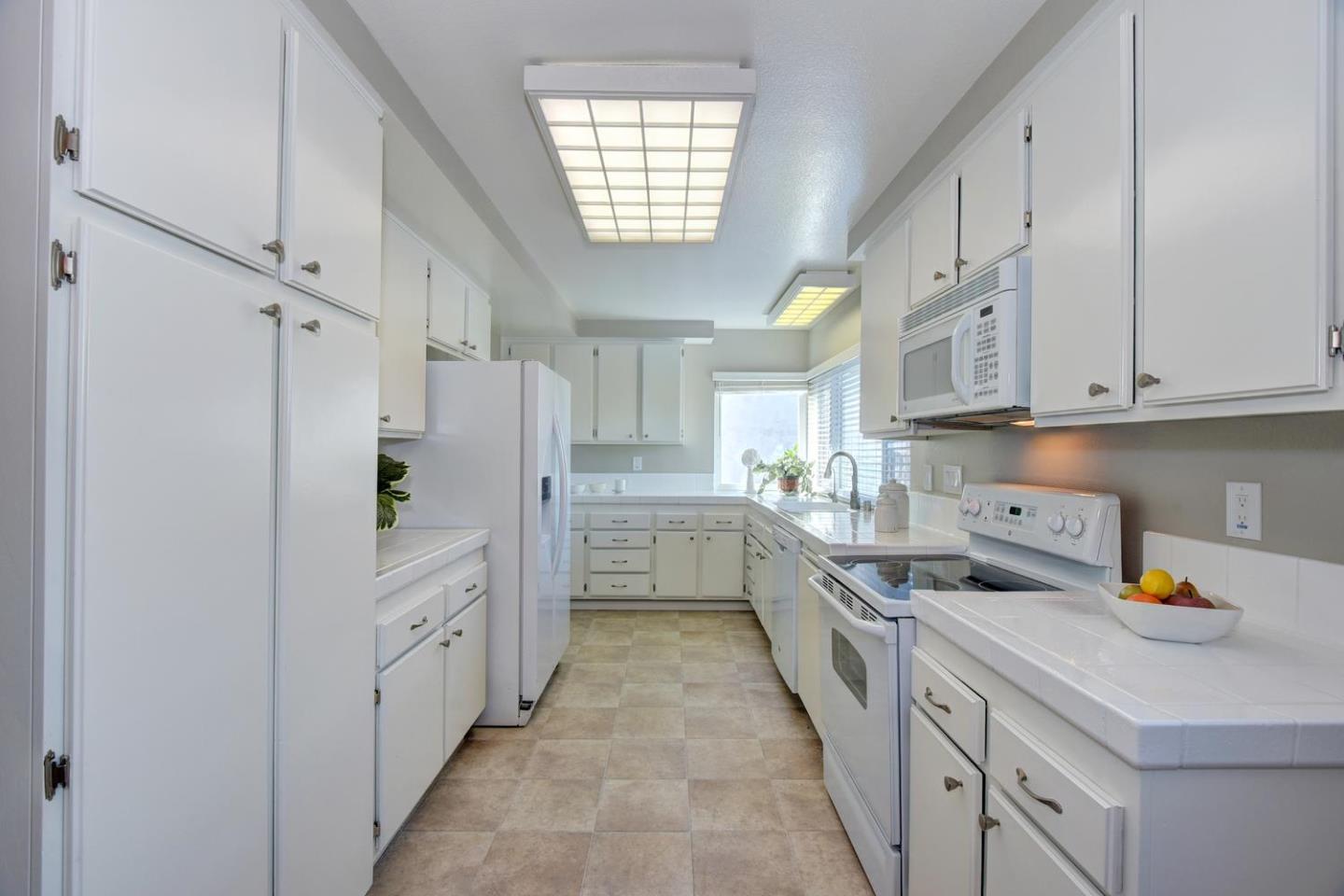 6429 McAbee Road San Jose, CA 95120 - Photo 13 of 28 a kitchen with white cabinets and white appliances