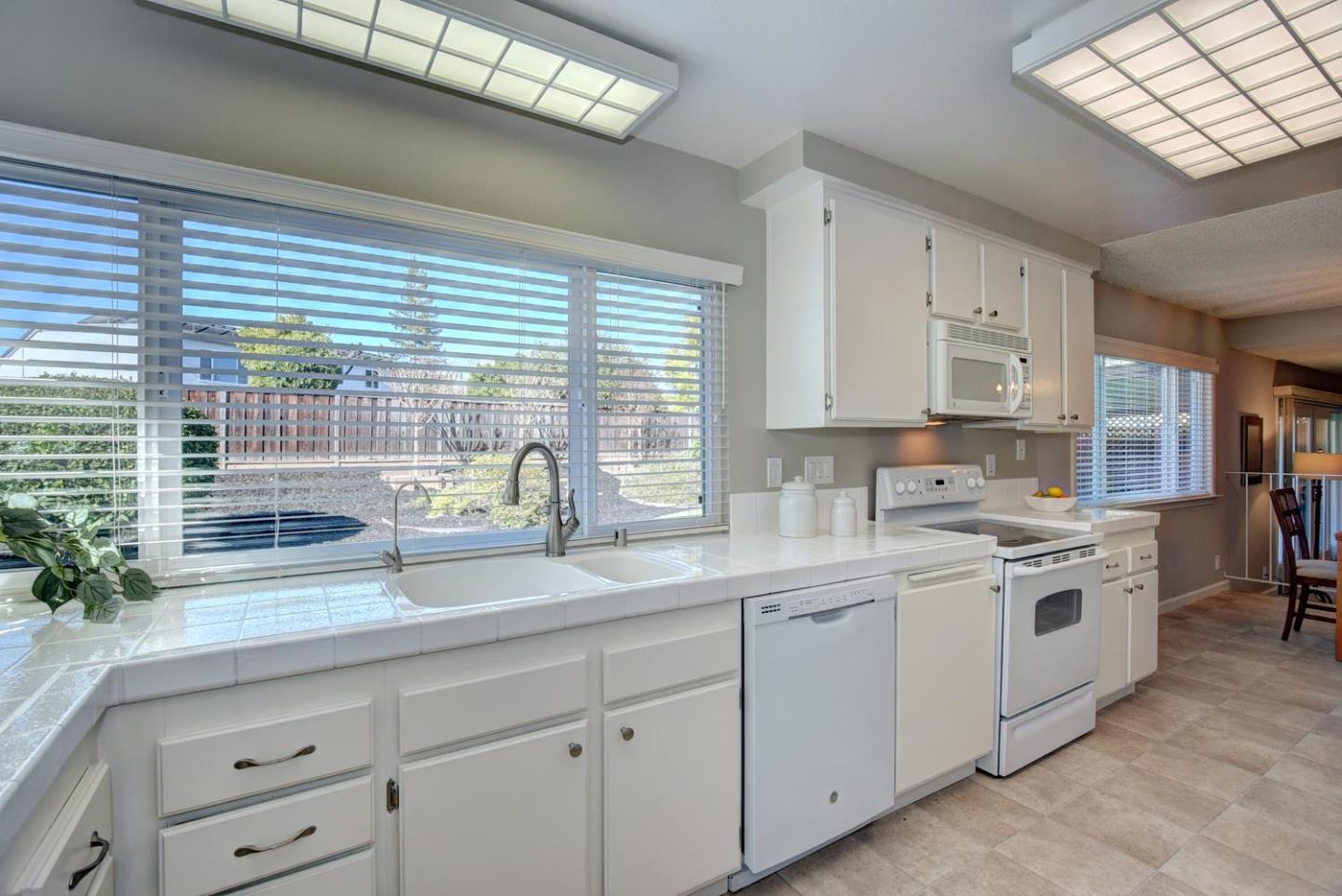 6429 McAbee Road San Jose, CA 95120 - Photo 14 of 28 a kitchen with white cabinets and white appliances
