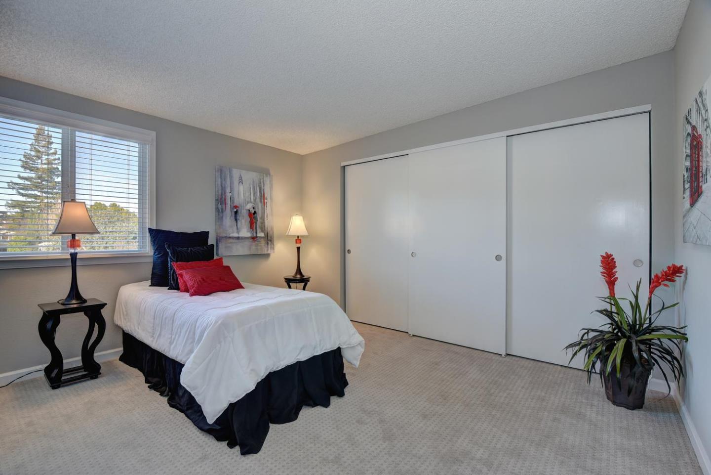 6429 McAbee Road San Jose, CA 95120 - Photo 19 of 28 a bedroom with a bed and a potted plant