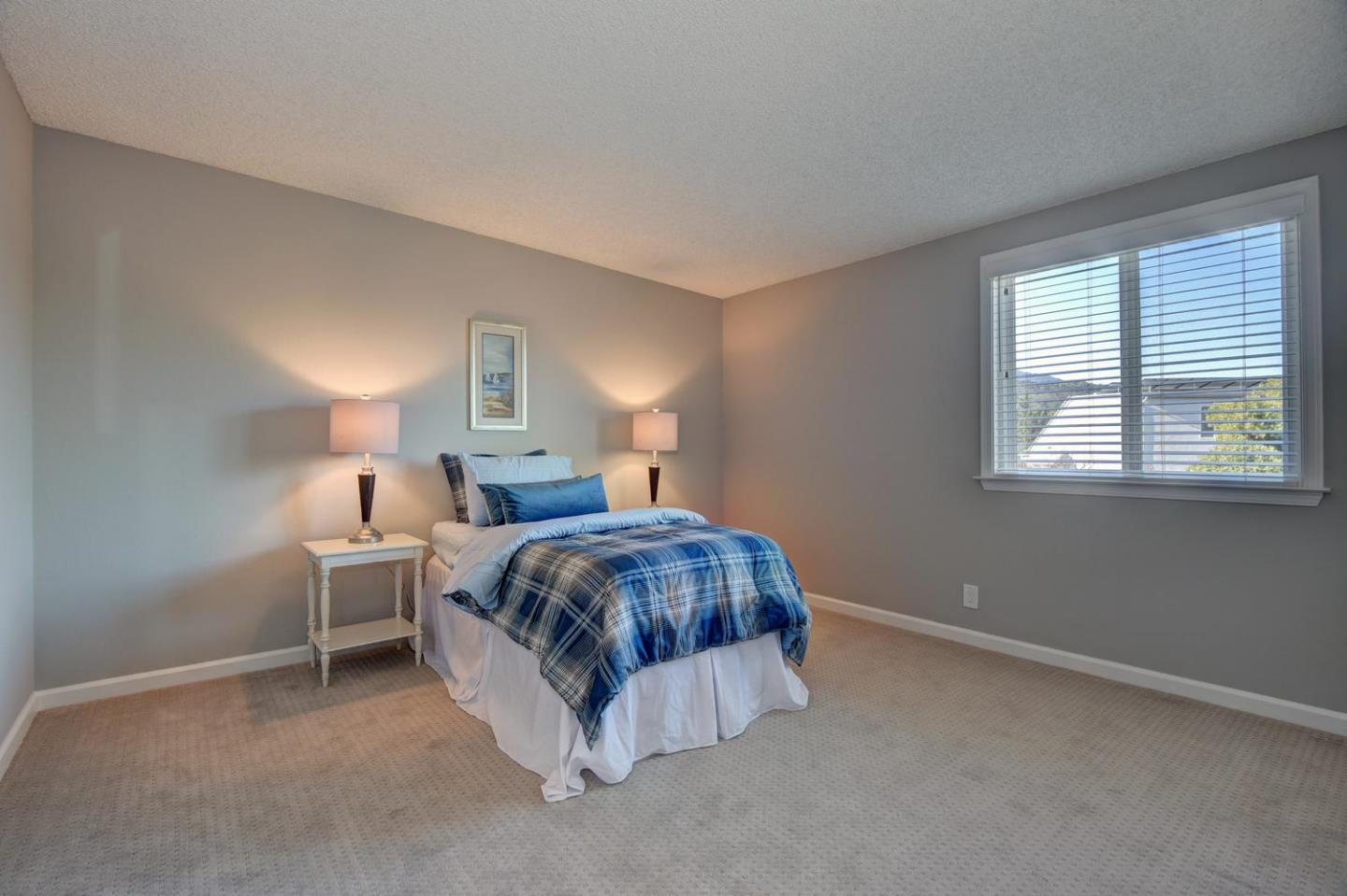 6429 McAbee Road San Jose, CA 95120 - Photo 20 of 28 a bedroom with a bed lamp and a window
