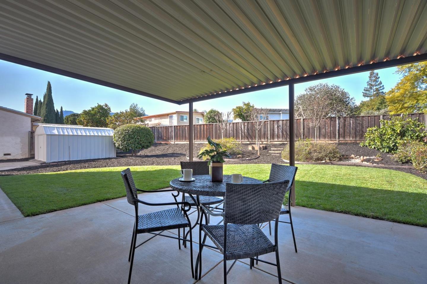 6429 McAbee Road San Jose, CA 95120 - Photo 27 of 28 a view of a patio with a table chairs and a yard