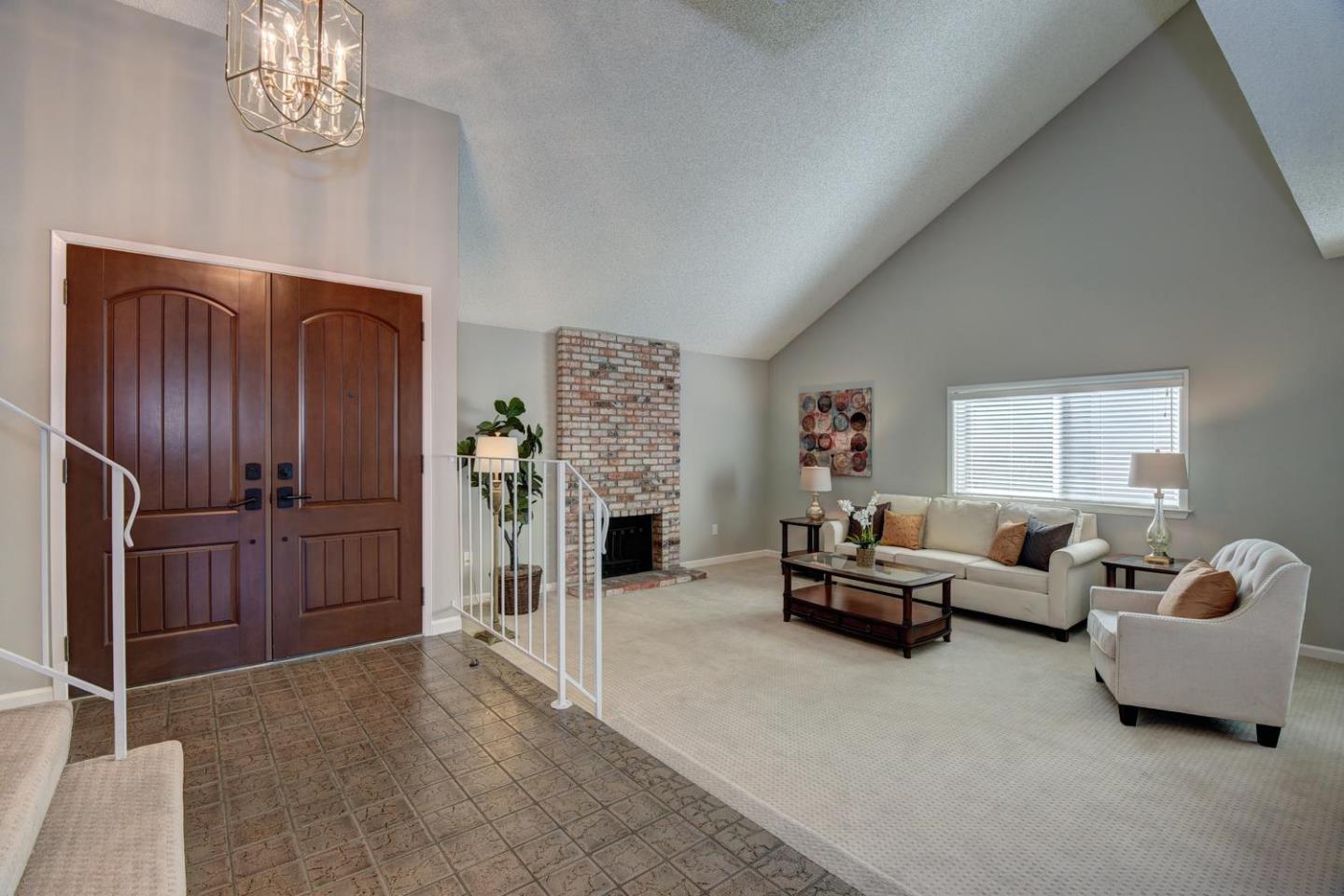 6429 McAbee Road San Jose, CA 95120 - Photo 3 of 28 a living room with furniture and a chandelier